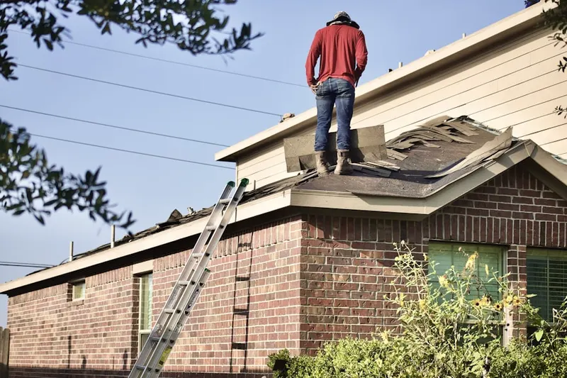 Professional roofer working on a residential roof in Conklin